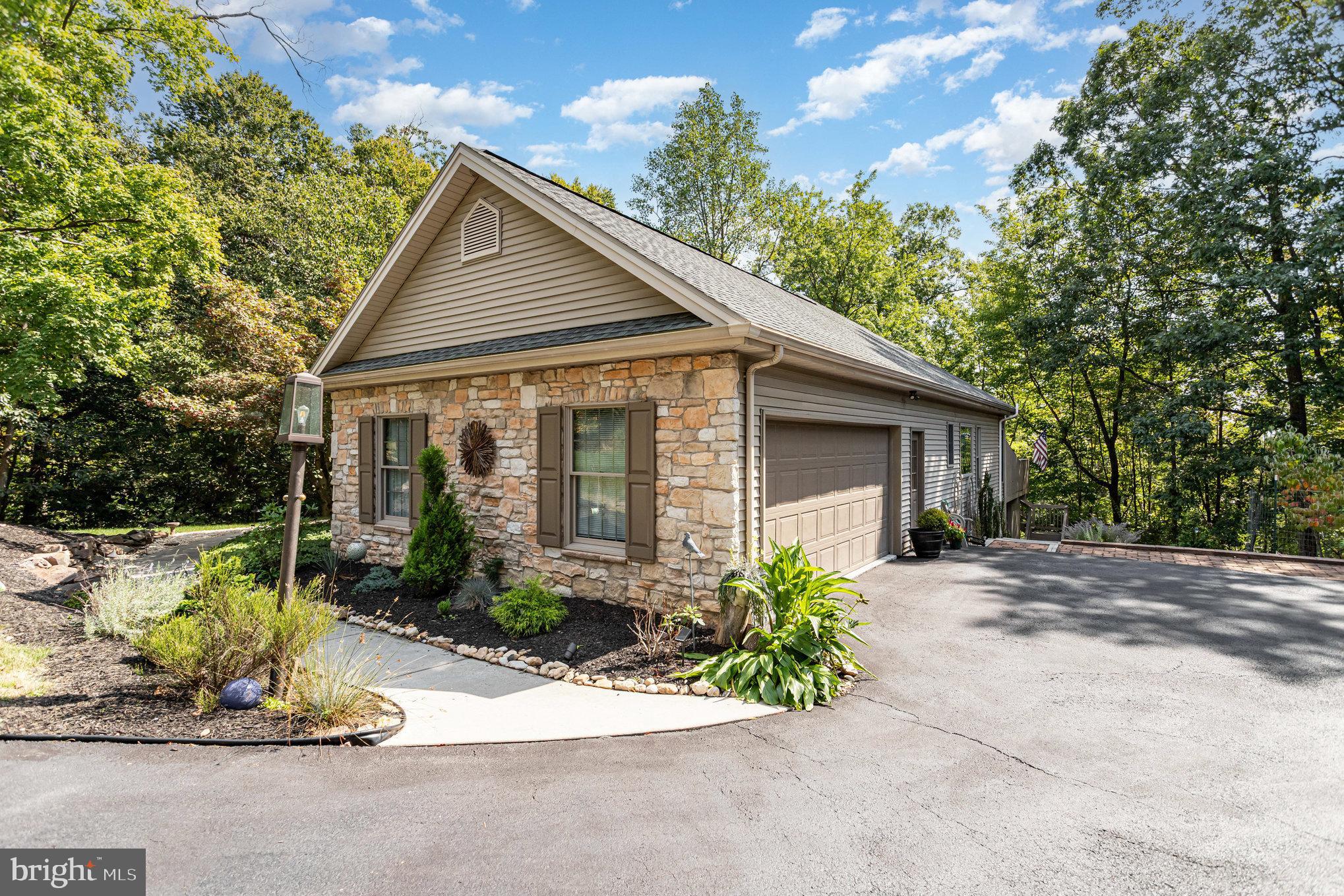 1817 Dogwood Road Harrisburg, PA 17110 - Photo 59 of 64 a front view of a house with a yard and potted plants