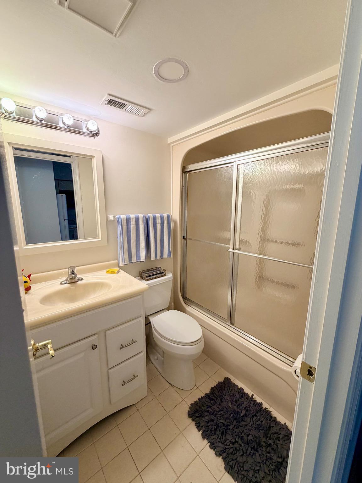 3 Queen Victoria Court Chester, MD 21619 - Photo 7 of 9 a bathroom with a sink a toilet a mirror a vanity and shower