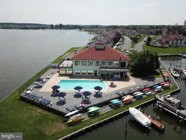 an aerial view of a house with a garden and lake view