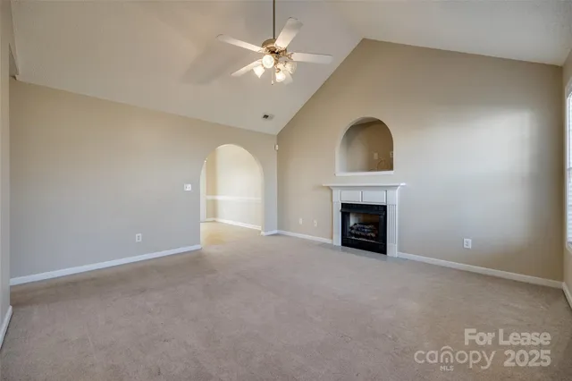 a view of an empty room with a fireplace