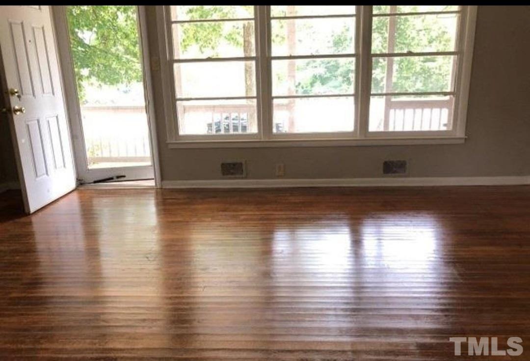 3218 Poole Road Raleigh, NC 27610 - Photo 2 of 6 wooden floor in an empty room with a window