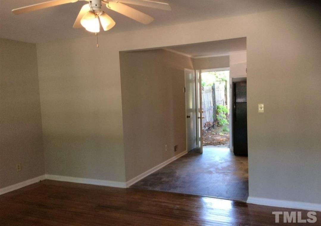 3218 Poole Road Raleigh, NC 27610 - Photo 3 of 6 an empty room with wooden floor and windows