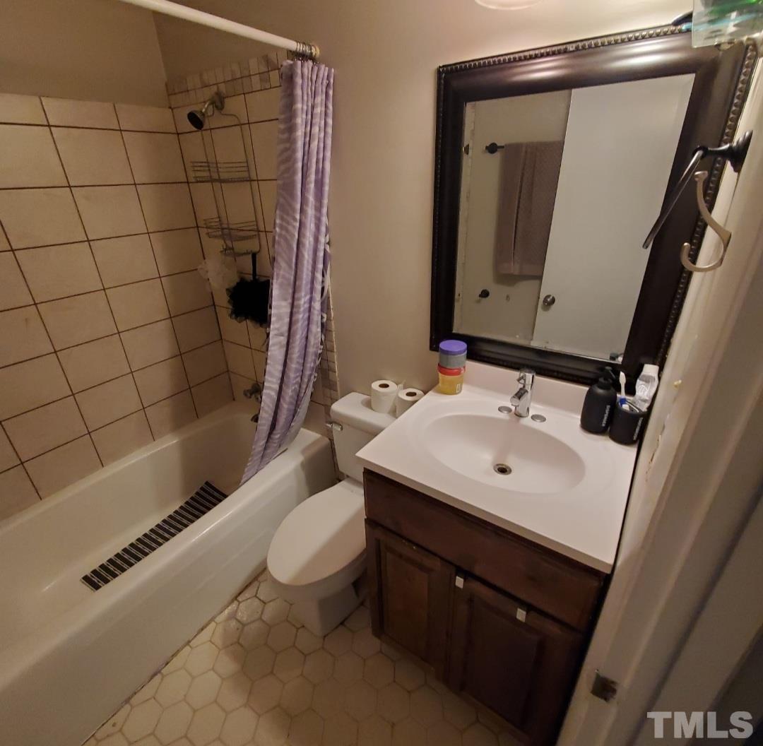 3218 Poole Road Raleigh, NC 27610 - Photo 5 of 6 a bathroom with a sink a toilet and shower