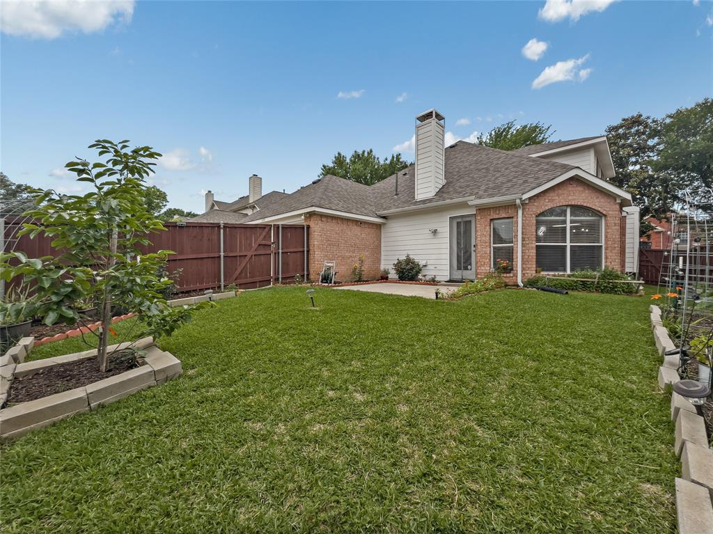 3008 Devlin Ridge Drive Plano, TX 75025 - Photo 18 of 24 Expansive backyard featuring a lush lawn, a privacy fence, and concrete patio
