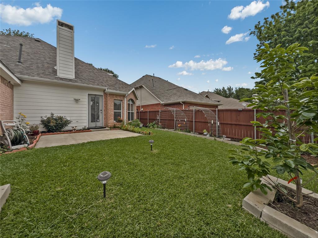 3008 Devlin Ridge Drive Plano, TX 75025 - Photo 20 of 24 Expansive backyard featuring a concrete patio, brick and siding exterior, and a wood privacy fence