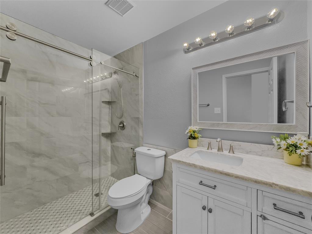 3008 Devlin Ridge Drive Plano, TX 75025 - Photo 23 of 24 Walk-in shower with clear glass enclosure and built-in shelving