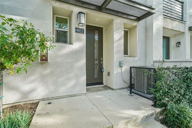 front view of a house with a potted plant
