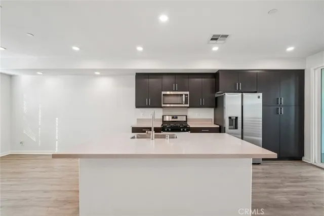 a kitchen that has a sink and a stove