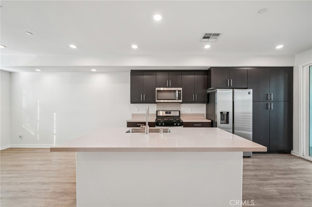 9422 Shade Place Rancho Cucamonga, CA 91730 - Photo 11 of 72 a kitchen with stainless steel appliances a refrigerator sink and microwave