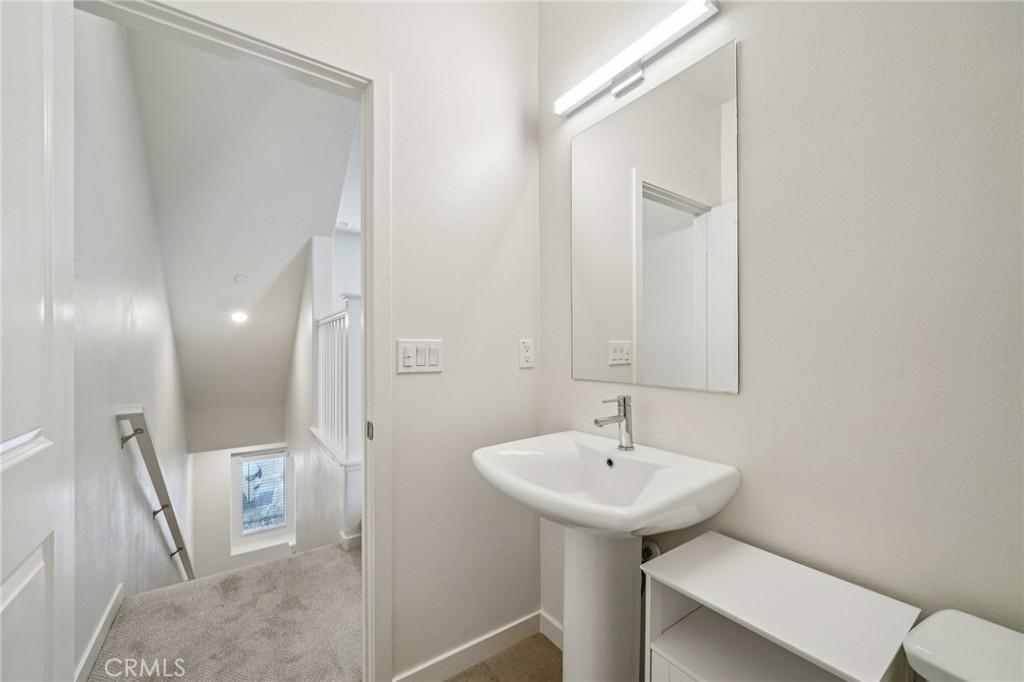 9422 Shade Place Rancho Cucamonga, CA 91730 - Photo 19 of 72 a bathroom with a sink a toilet and a mirror