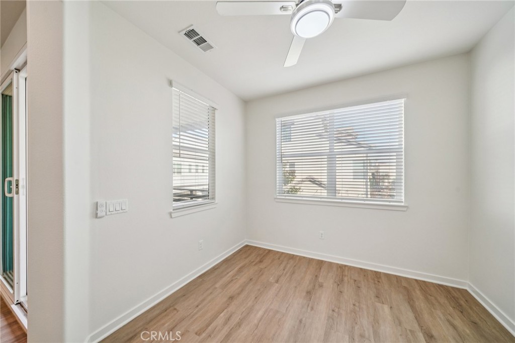 9422 Shade Place Rancho Cucamonga, CA 91730 - Photo 20 of 72 a view of an empty room with wooden floor and a window