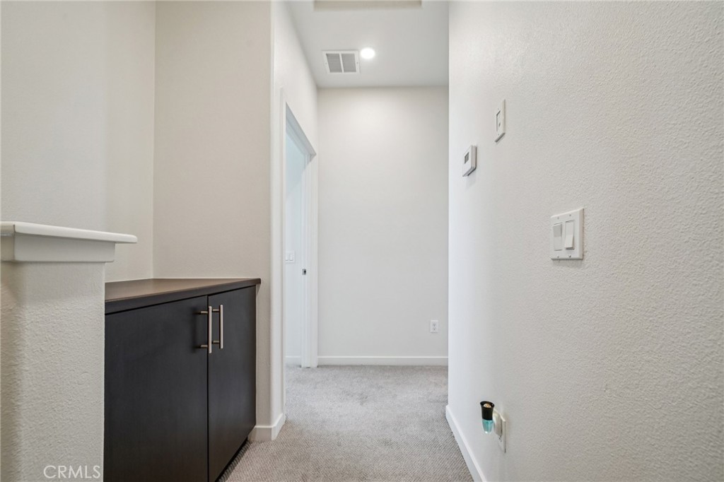 9422 Shade Place Rancho Cucamonga, CA 91730 - Photo 23 of 72 a view of hallway with closet and a white door