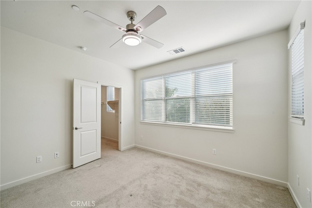 9422 Shade Place Rancho Cucamonga, CA 91730 - Photo 24 of 72 an empty room with chandelier fan and windows
