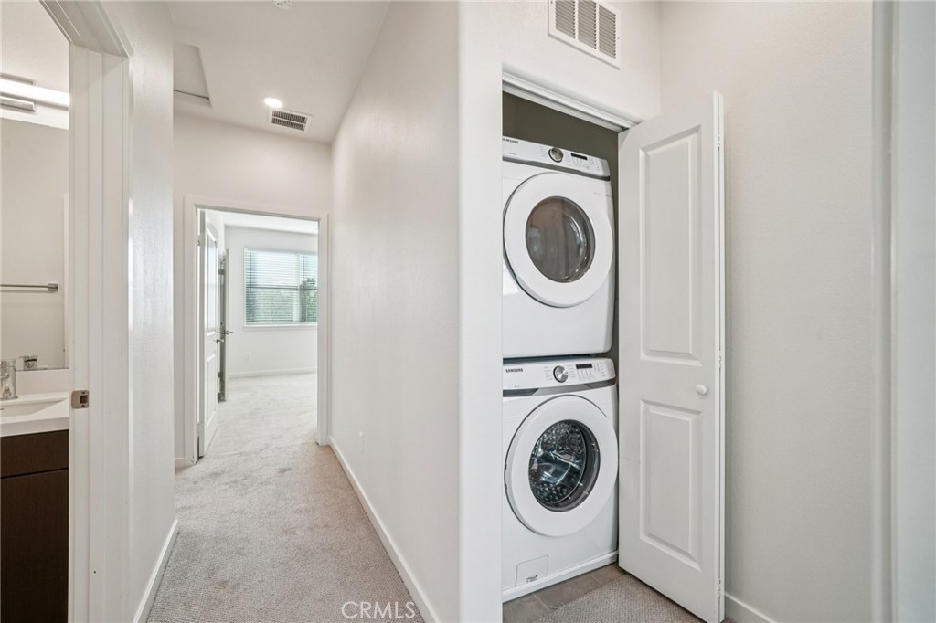 9422 Shade Place Rancho Cucamonga, CA 91730 - Photo 36 of 72 a view of a hallway with washer and dryer