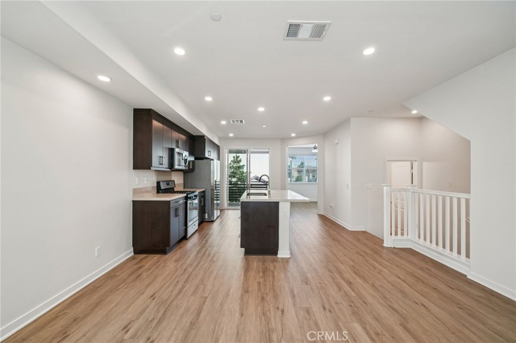 9422 Shade Place Rancho Cucamonga, CA 91730 - Photo 7 of 72 a kitchen with stainless steel appliances kitchen island granite countertop a stove top oven a sink and a refrigerator