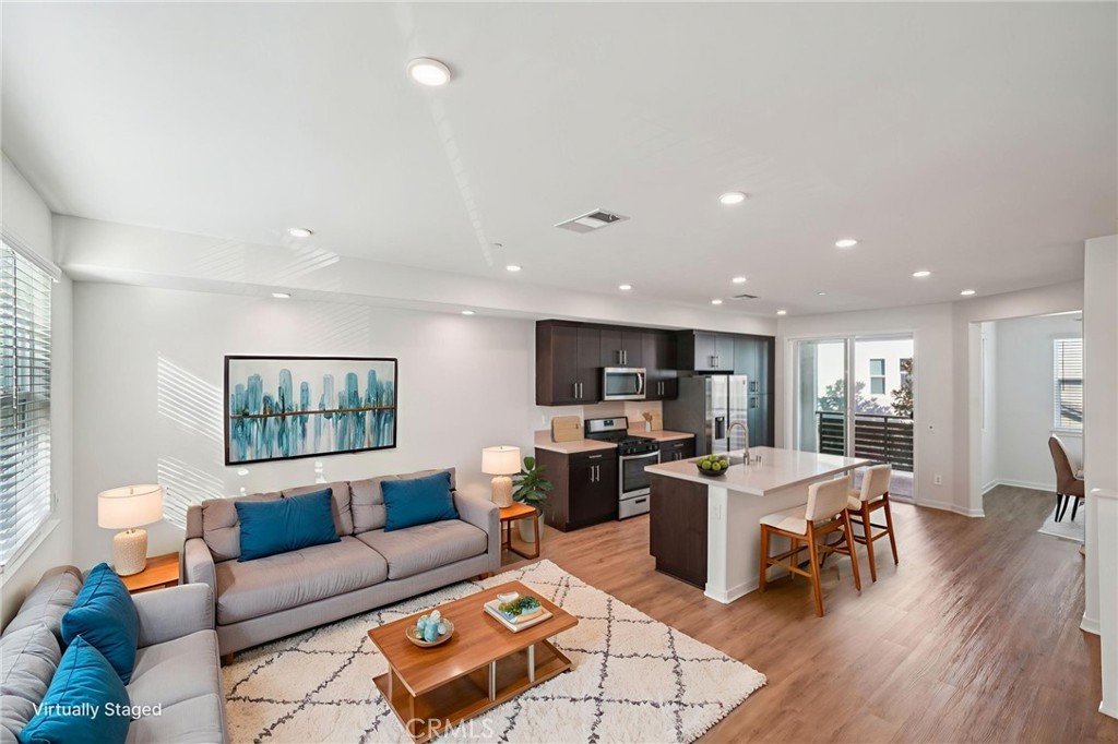 9422 Shade Place Rancho Cucamonga, CA 91730 - Photo 10 of 72 a living room with furniture kitchen view and a flat screen tv