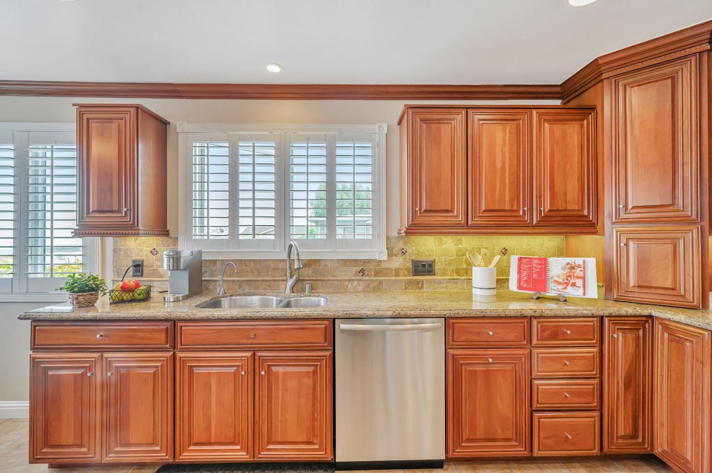 305 La Prenda Millbrae, CA 94030 - Photo 16 of 50 a kitchen with stainless steel appliances granite countertop a sink dishwasher stove and cabinets with wooden floor