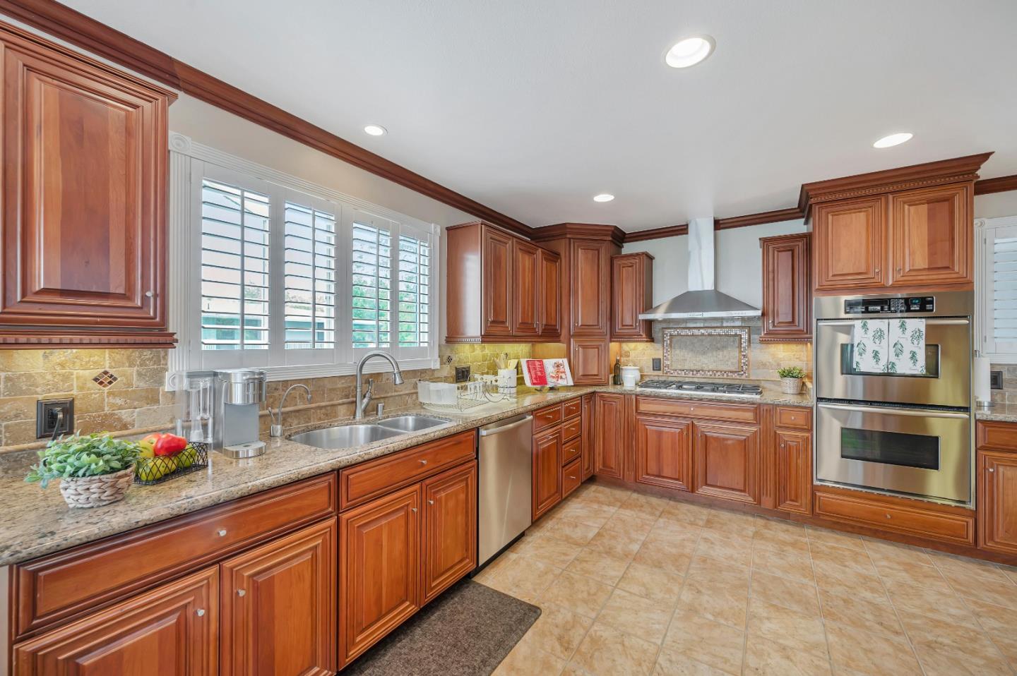 305 La Prenda Millbrae, CA 94030 - Photo 17 of 50 a kitchen with granite countertop stainless steel appliances a sink window and cabinets