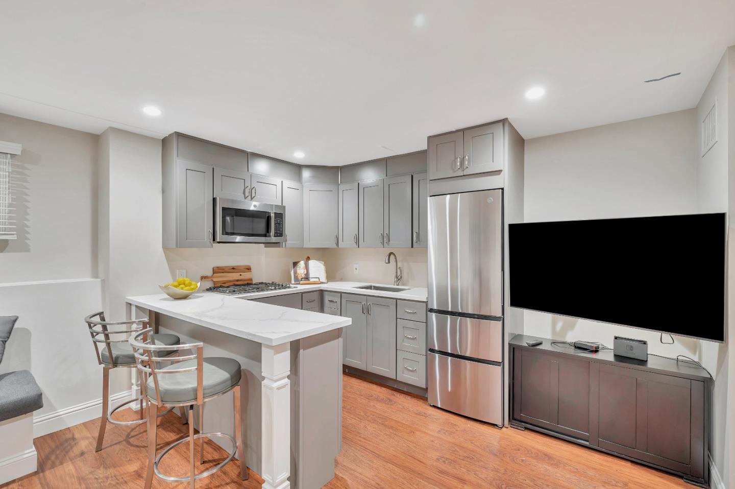 305 La Prenda Millbrae, CA 94030 - Photo 23 of 50 a kitchen with stainless steel appliances a stove a refrigerator a sink dishwasher with a dining table and chairs