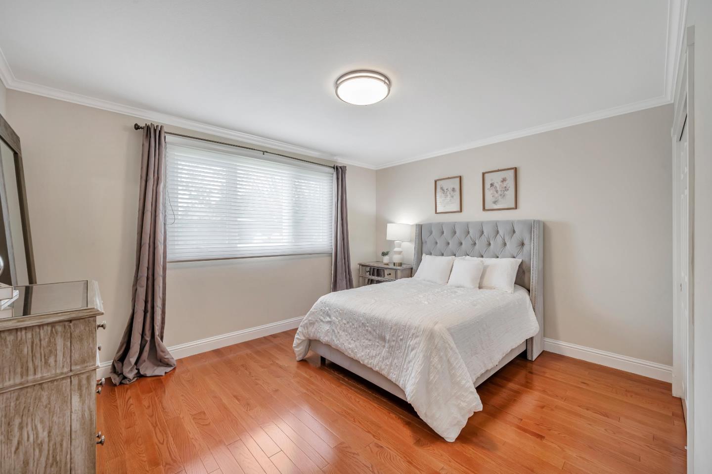 305 La Prenda Millbrae, CA 94030 - Photo 25 of 50 a large bed sitting in a bedroom next to a window