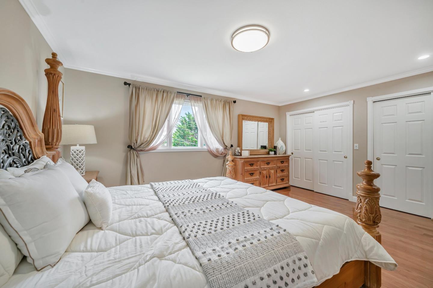 305 La Prenda Millbrae, CA 94030 - Photo 29 of 50 a large bedroom with a bed and wooden floor