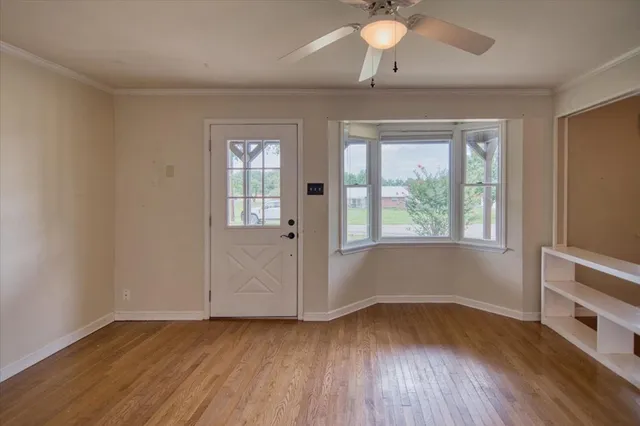 wooden floor in an empty room with a window