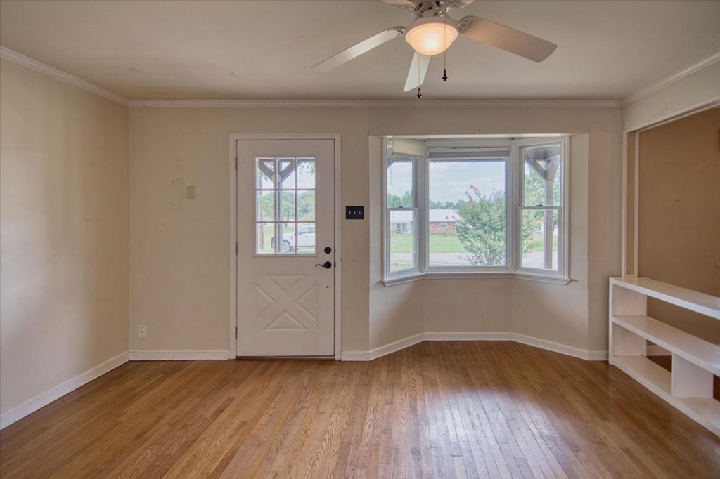 1013 Church Street Mason, TX 76856 - Photo 11 of 25 wooden floor in an empty room with a window