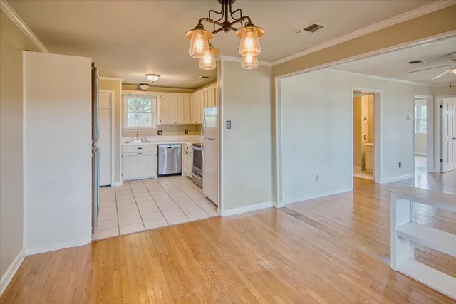 a open kitchen with a sink dishwasher a refrigerator and wooden floor