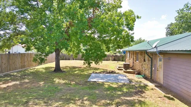 a view of a backyard with a tree