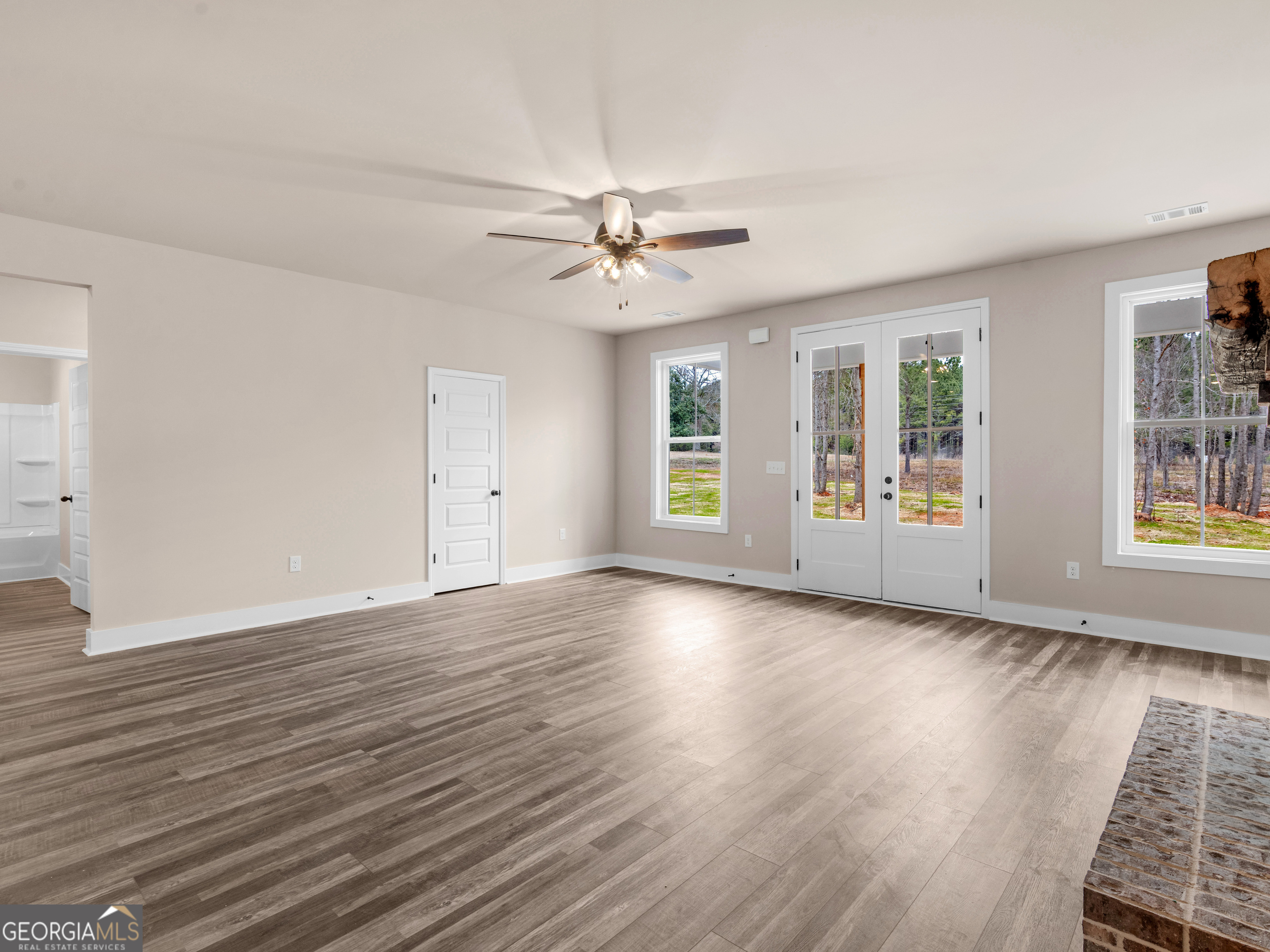 160 Loyd Road Mansfield, GA 30056 - Photo 17 of 53 an empty room with wooden floor and windows