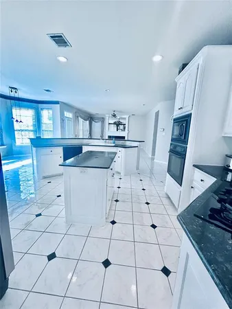 a kitchen with stainless steel appliances cabinets a sink and a stove