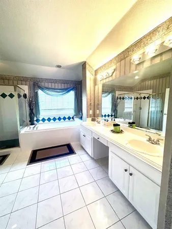 a large white kitchen with a large window