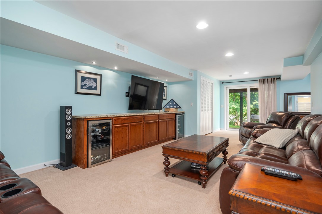 130 Bear Hill Road, Unit 302 Cumberland, RI 02864 - Photo 29 of 42 Lower level family room with great built-ins and a slider to the patio