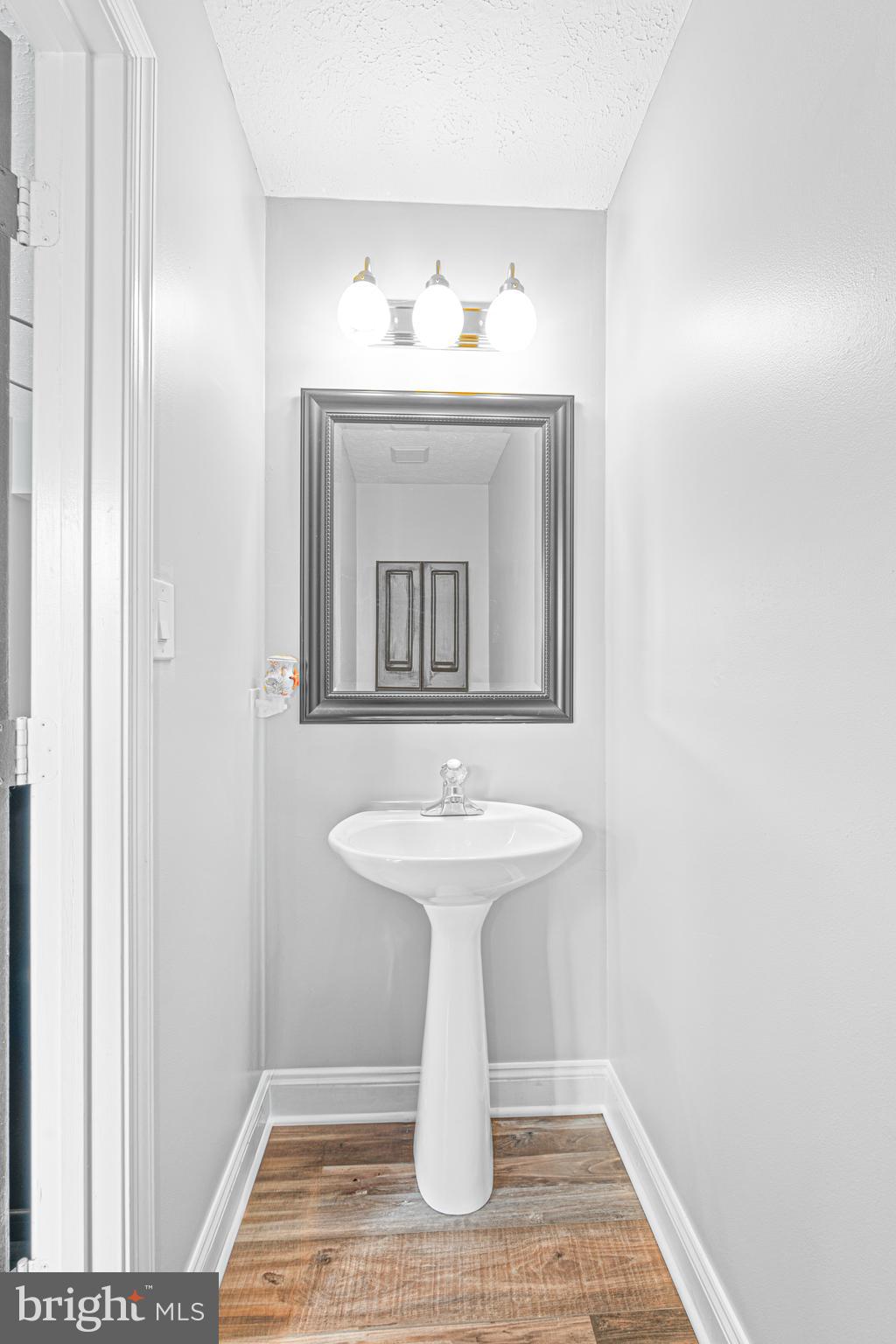 631 Kittendale Road Baltimore, MD 21220 - Photo 23 of 27 a bathroom with a sink and a mirror