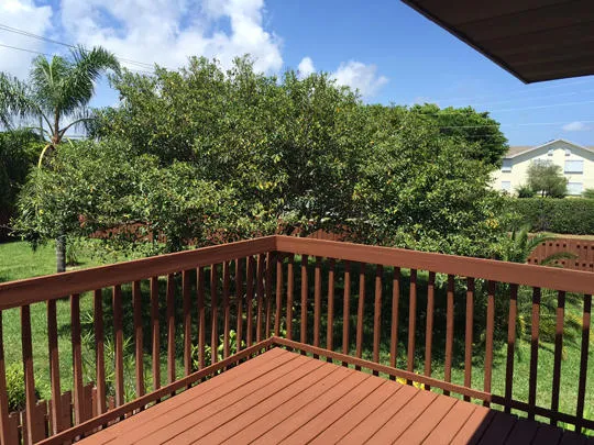a balcony with wooden floor and fence