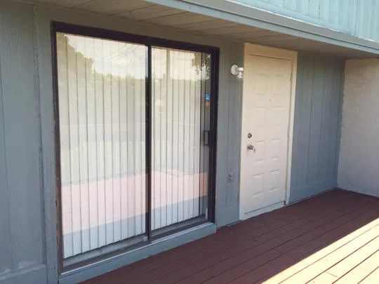 a view of a room that has wooden floor and windows