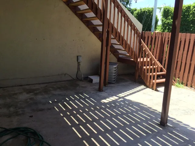 a view of balcony with wooden floor and fence