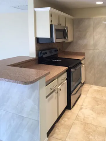 a kitchen with stainless steel appliances a sink dishwasher stove and microwave
