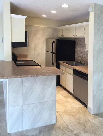 a large kitchen with a stove and a sink