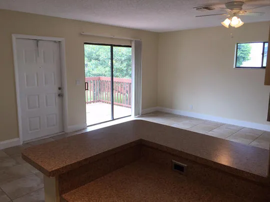 a room with a window and a ceiling fan