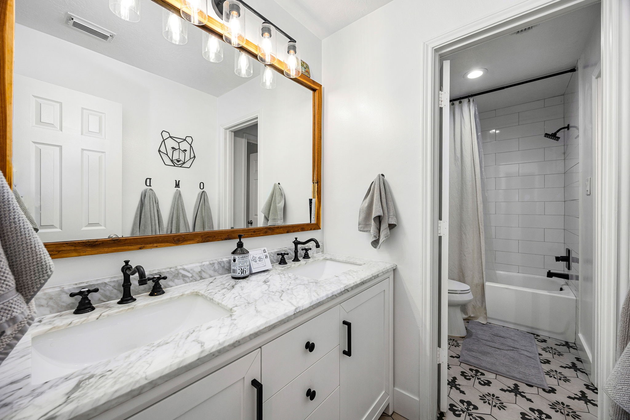 23107 Burcan Court Spring, TX 77373 - Photo 30 of 42 a bathroom with a granite countertop sink and a mirror