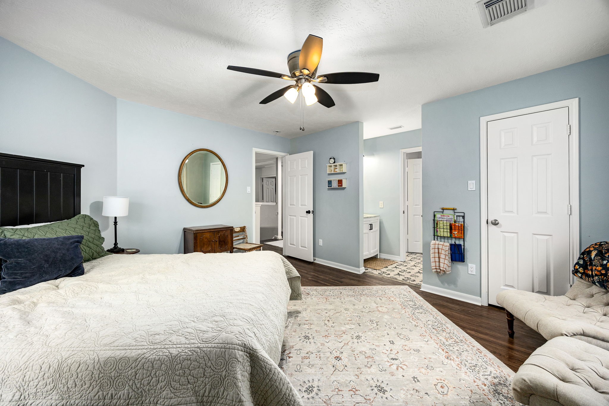 23107 Burcan Court Spring, TX 77373 - Photo 32 of 42 a bedroom with a large bed and a chandelier