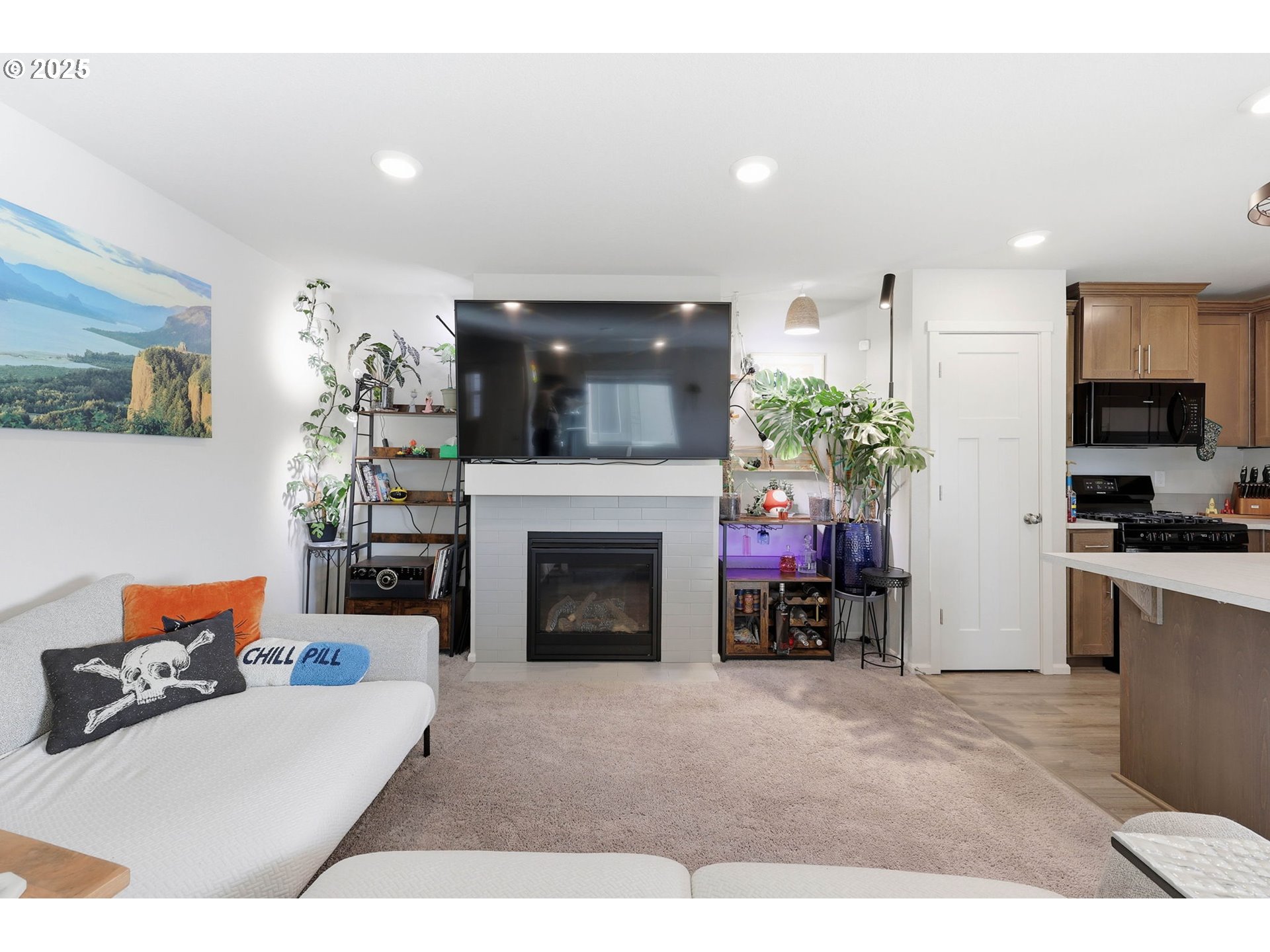 1316 19th Place Forest Grove, OR 97116 - Photo 11 of 36 a living room with furniture a fireplace and a flat screen tv