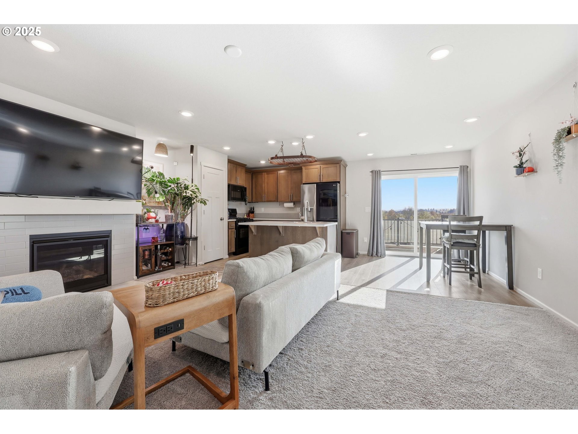1316 19th Place Forest Grove, OR 97116 - Photo 12 of 36 a living room with furniture a fireplace and a flat screen tv