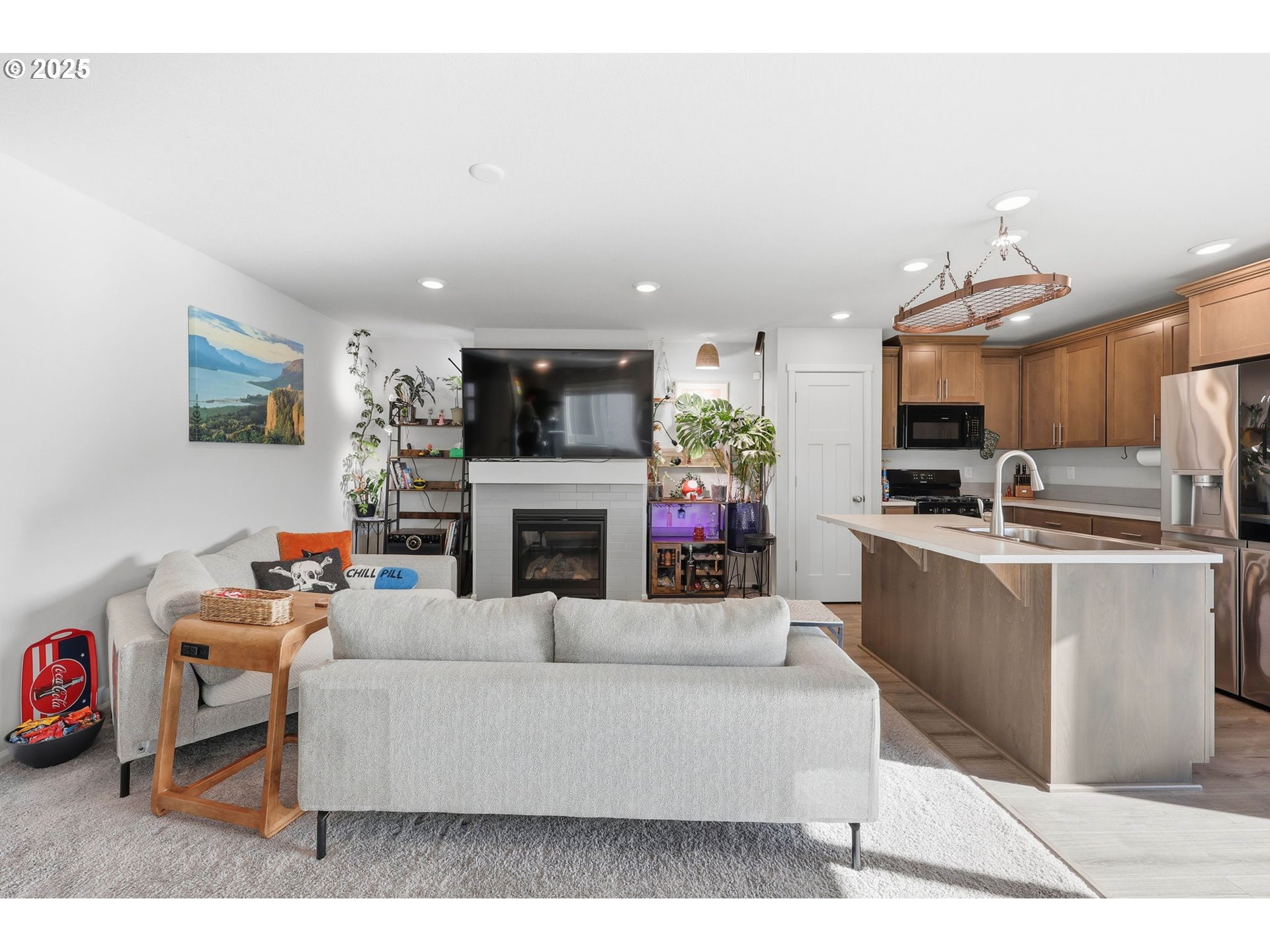 1316 19th Place Forest Grove, OR 97116 - Photo 13 of 36 a living room with furniture a fireplace and a flat screen tv