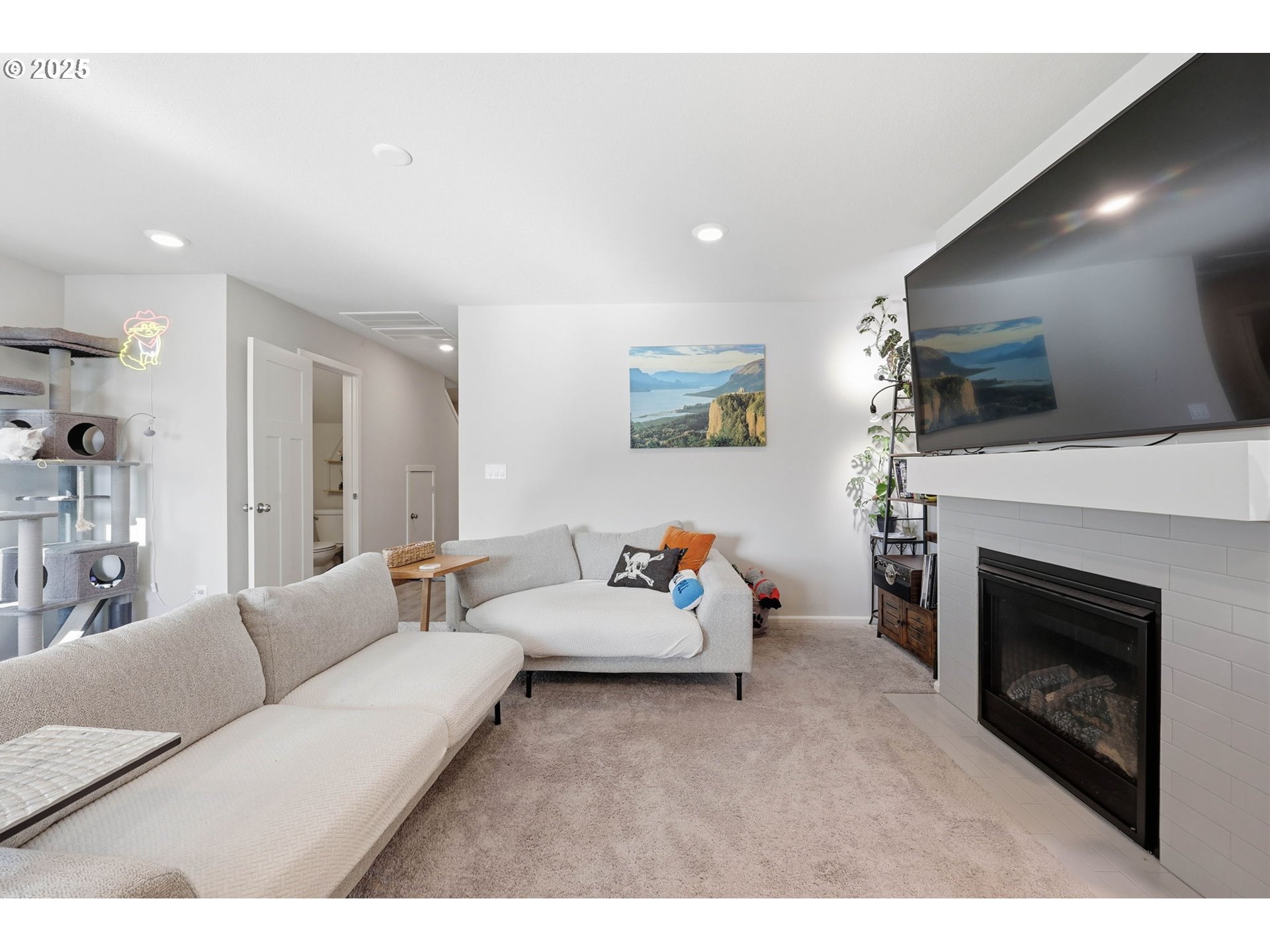 1316 19th Place Forest Grove, OR 97116 - Photo 14 of 36 a living room with furniture a flat screen tv and a fireplace