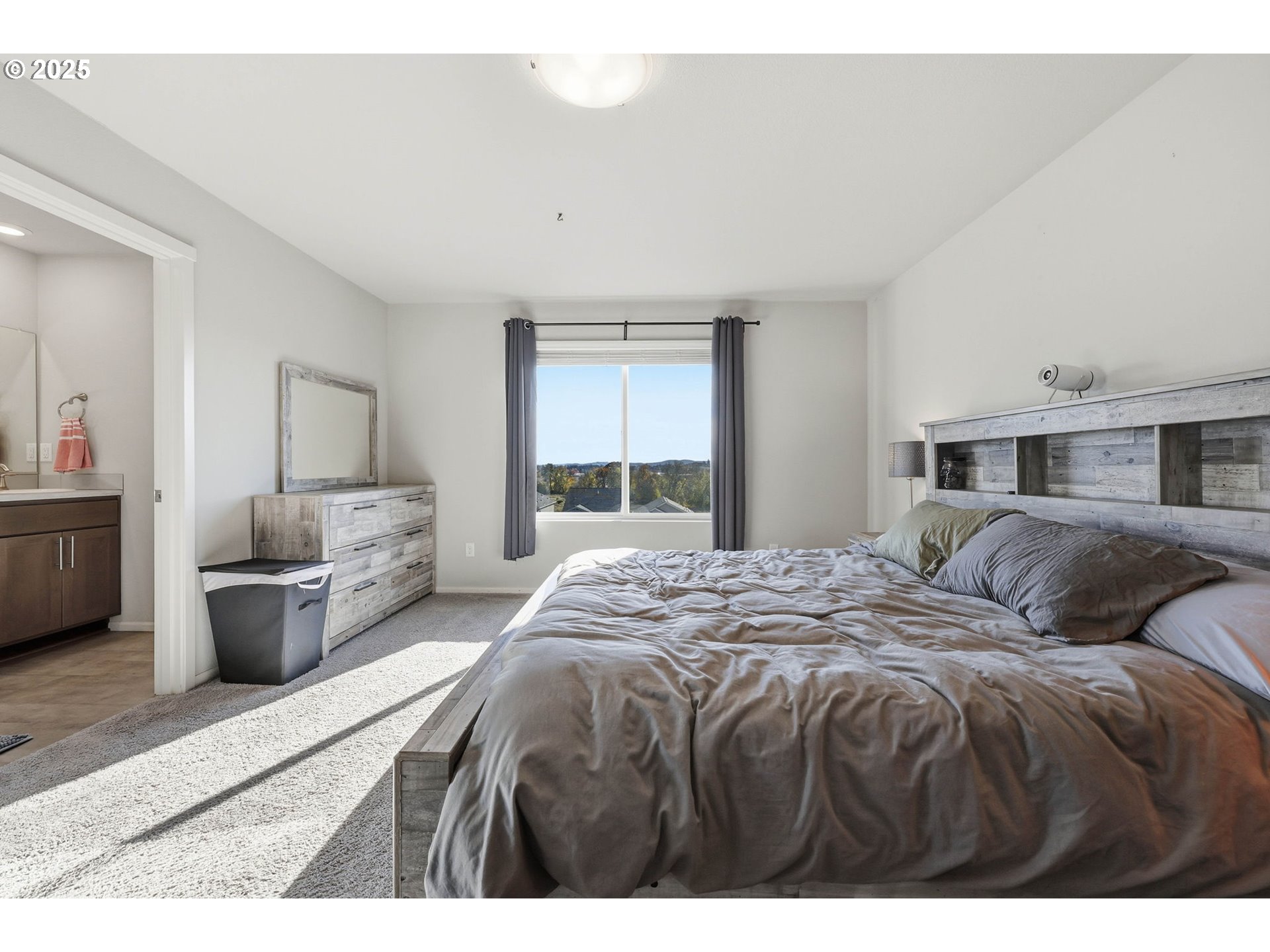 1316 19th Place Forest Grove, OR 97116 - Photo 21 of 36 a bedroom with a large bed and a large window