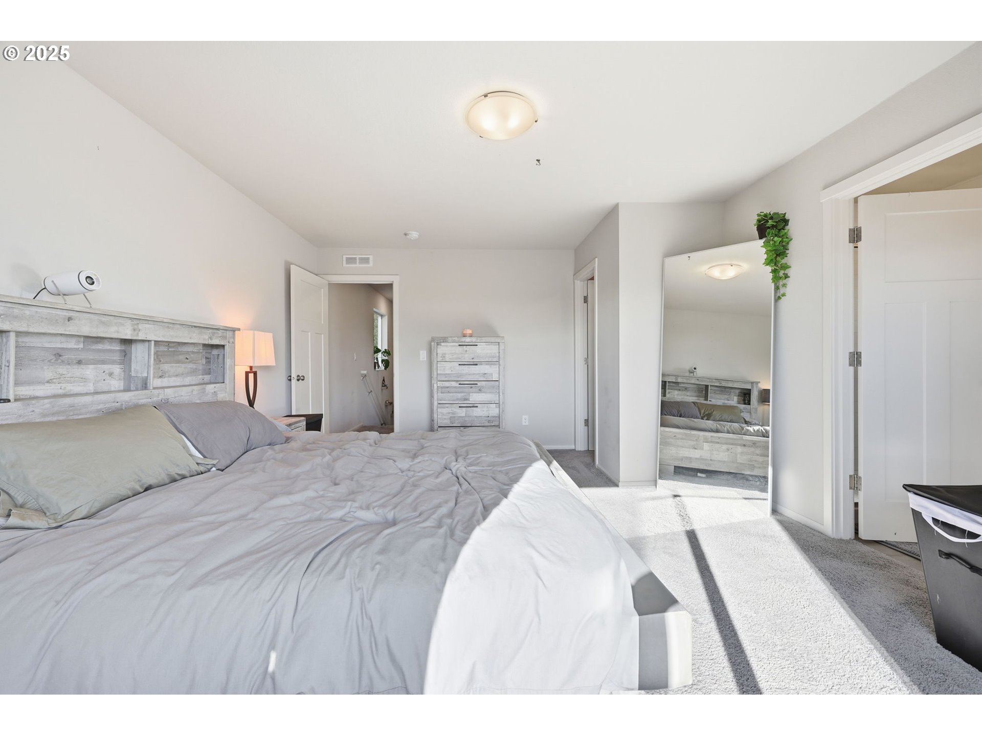 1316 19th Place Forest Grove, OR 97116 - Photo 23 of 36 a bedroom with a large bed and a chandelier