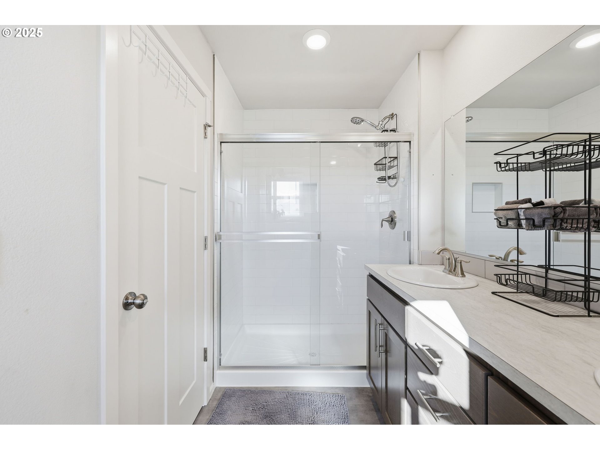 1316 19th Place Forest Grove, OR 97116 - Photo 26 of 36 a bathroom with a sink a shower a mirror and a bathtub