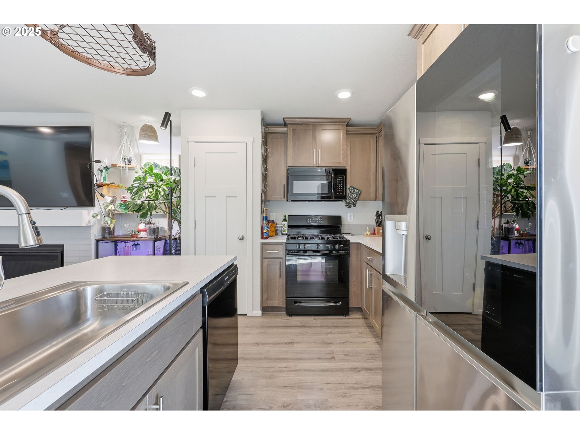 1316 19th Place Forest Grove, OR 97116 - Photo 7 of 36 a kitchen with kitchen island white cabinets and stainless steel appliances